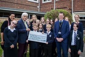 Cliff Southcombe of Social Enterprise International Ltd presents a 15,942 Euros cheque to Whitby's Eskdale School.