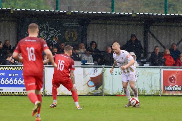 Danny Earl was on target as Bridlington Town earned a crucial 2-0 win at Grimsby Borough to seal their NPL East Division survival.
