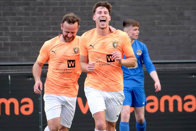 Scorer of the third goal, Kieran Link, right, celebrates with teammate Gary Thomas.