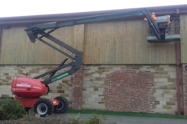 Using a cherry picker to install the nesting boxes