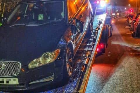 The black Jaguar involved in a collision with a cyclist is recovered.