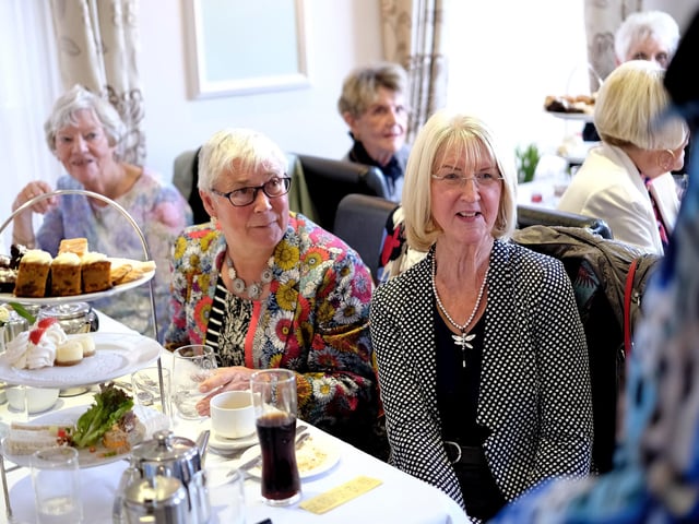 Enjoying the fashions and their afternoon tea!
