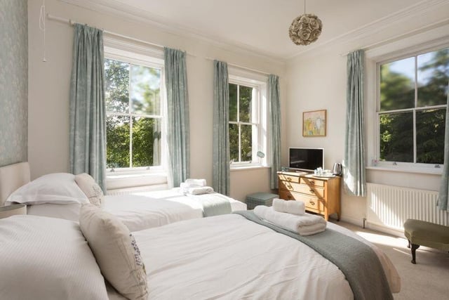 A spacious bedroom with plenty of natural light from double aspect windows.