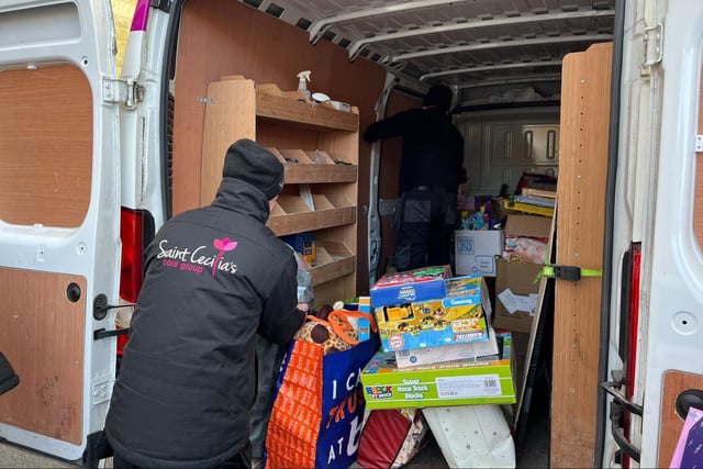 Loading one of the vans full of toys.