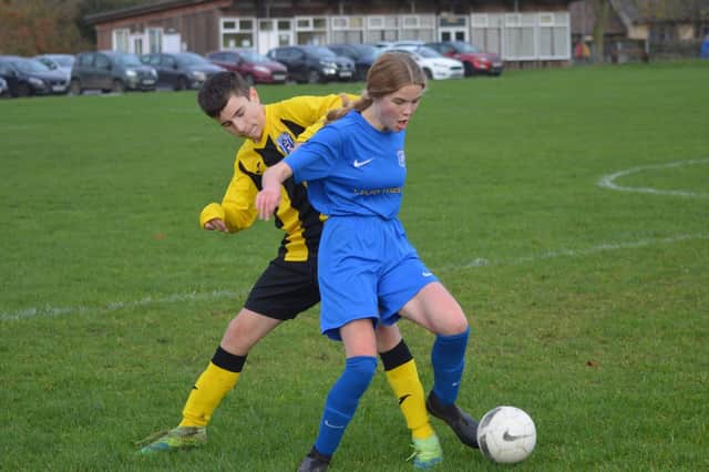 Heslerton under-14s (blue kit) hold off a Scalby Under-14s [player in the Scarborough & District Minor Leaguer clash PHOTO BY CHERIE ALLARDICE