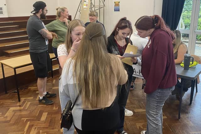 Students excitedly opened their results in the school hall.