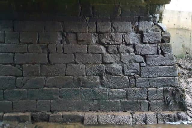 Spital Old Bridge. Open joints on south abutment and cracked stones.