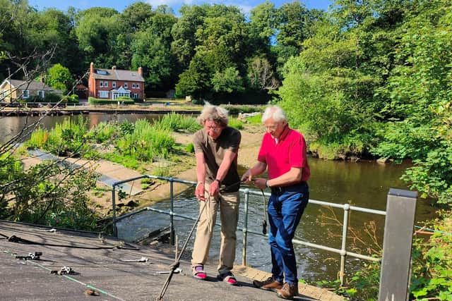 Rory Newman and Mike Ford, right, maintain the Archimedes' screw at Ruswarp Weir. Photo: Paul Drury-Bradey