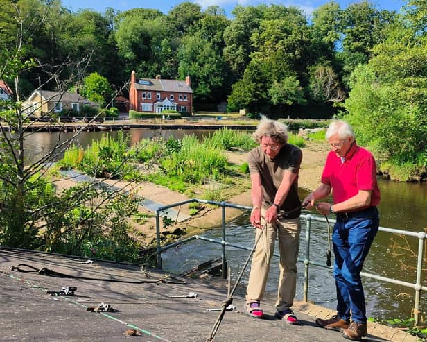 Rory Newman and Mike Ford, right, maintain the Archimedes' screw at Ruswarp Weir. Photo: Paul Drury-Bradey