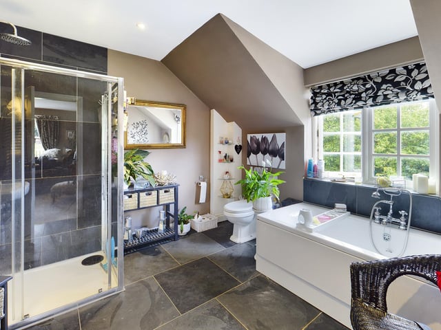 This bathroom has both a walk-in shower and a bath with central mixer tap.