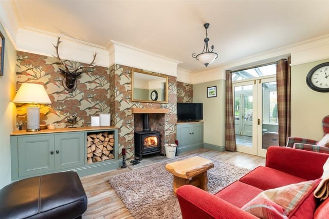 The snug has a cosy stove and wooden floor with underfloor heating.