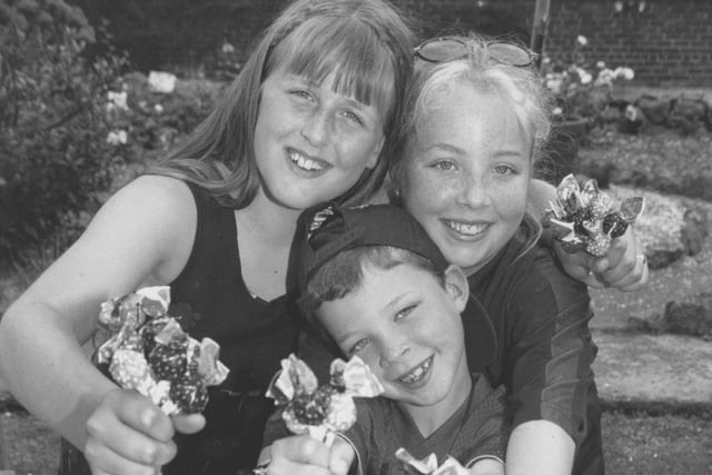 Resisting the temptation to eat the sweets are youngsters, left to right, Samantha Eblet, Beaver Joe Healy and his sister Katie who helped out on the stall at the Filey Scout Group Gala Day back in July 1997. 