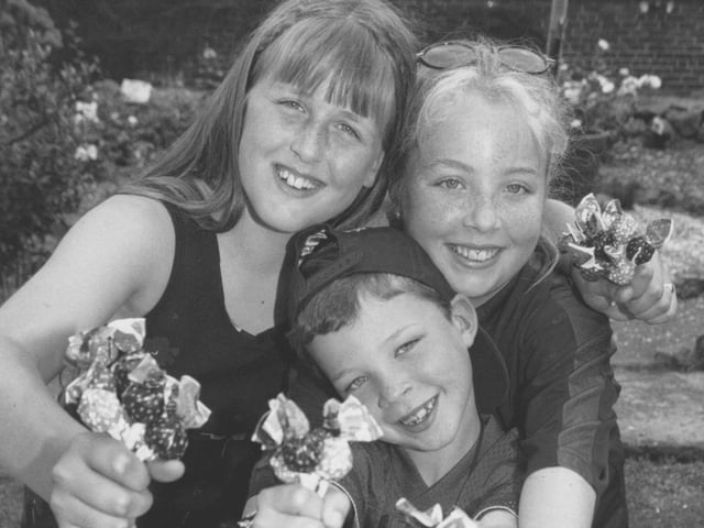 Resisting the temptation to eat the sweets are youngsters, left to right, Samantha Eblet, Beaver Joe Healy and his sister Katie who helped out on the stall at the Filey Scout Group Gala Day back in July 1997. 