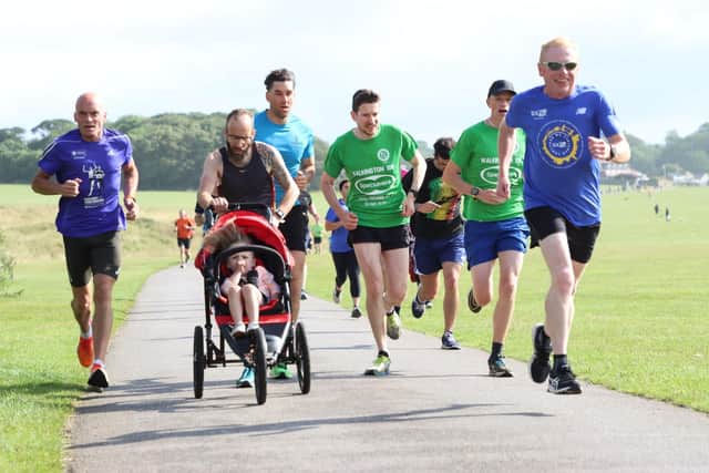 Bridlington Road Runners stalwart Phill Taylor, pushing the buggy, battles for a decent position early in the Sewerby parkrun.