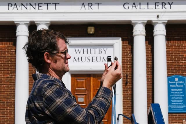 Dr Liam Herringshaw at Whitby Museum with the ‘garlic stones’. photo: Tony Bartholomew