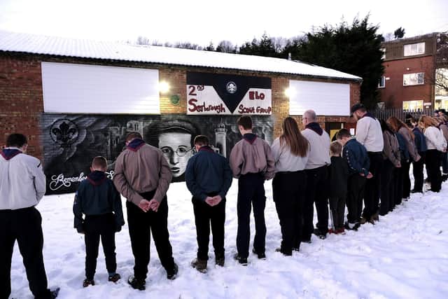 Scouts address a minute's silence at the mural and plaque unveiling.
