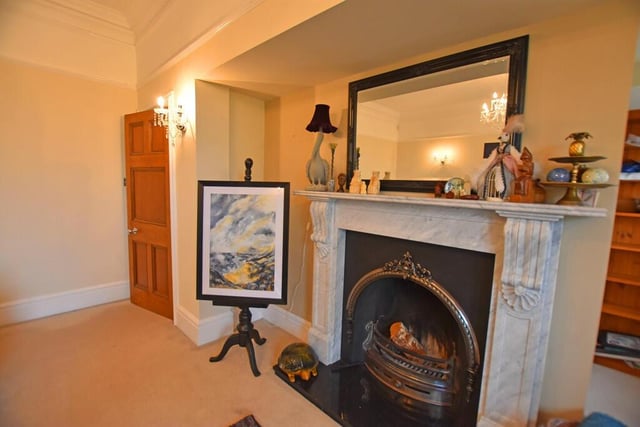 The striking period fireplace is set within an alcove.