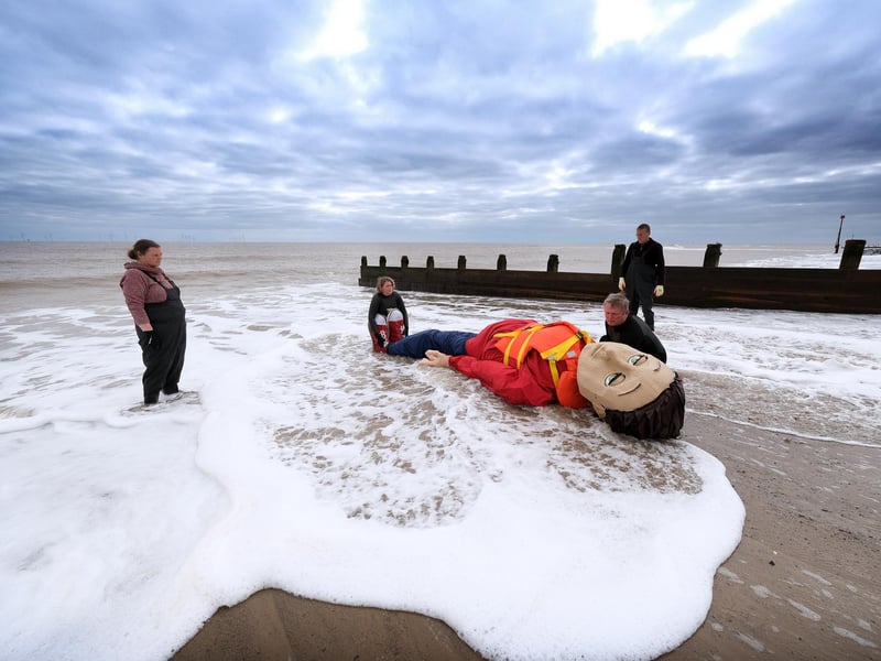 Cast ashore on the Yorkshire Coast, Aura was embraced by local communities who wrapped her in a large blanket composed of uniquely designed squares, each knitted by individuals and groups within the community with their own message.