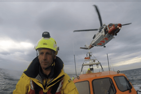 Whitby RNLI’s Shannon class all-weather lifeboat takes part in a training exercise with the HM Coastguard helicopter, practising winch operations for medical evacuations at sea. Photo credit: Whitby RNLI.