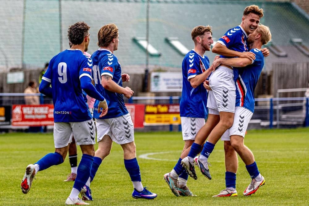 Whitby Town players congratulate Callum Hickman after he scored the winning goal in the 1-0 home success against Curzon Ashton. Photo by Brian Murfield