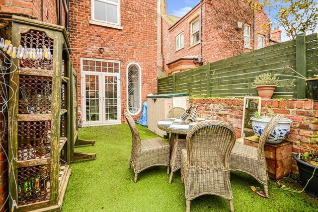 The rear enclosed garden provides sheltered space for al fresco dining.