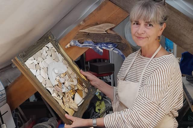Jo shows off her creations - the dolphin in the background was inspired by the shape of one of her finds