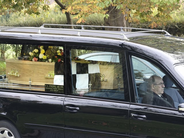 Mr Emmerson's coffin was draped with a chequered flag
