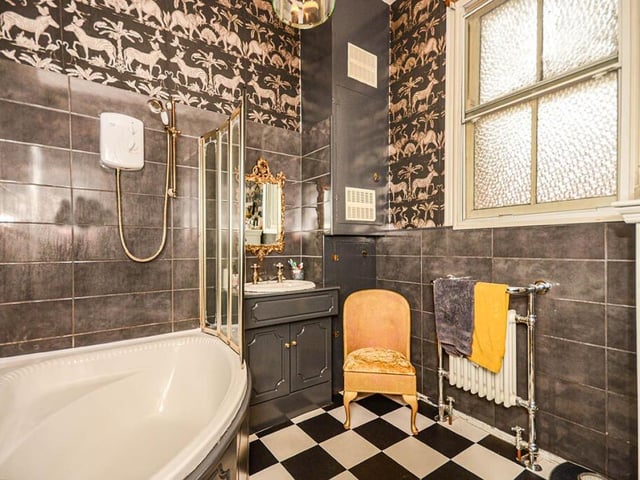 A stylish bathroom, with corner bath and shower.
