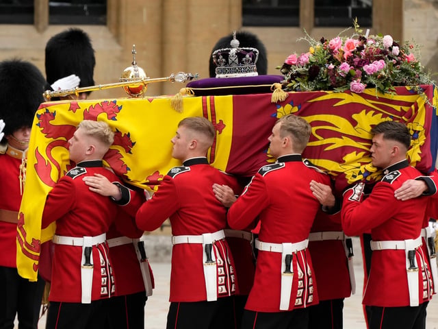 The coffin of Queen Elizabeth II with the Imperial State Crown resting on top is carried by the Bearer Party into Westminster Abbey during the State Funeral of Queen Elizabeth II.  (Photo by Christopher Furlong/Getty Images)