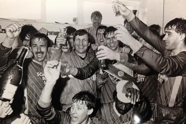 Boss Neil Warnock, Mitch Cook and his fellow Scarborough FC players celebrate promotion to the Football League