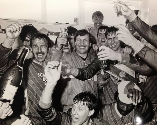 Boss Neil Warnock, Mitch Cook and his fellow Scarborough FC players celebrate promotion to the Football League