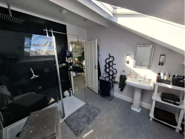A modern bathroom with walk in shower unit.