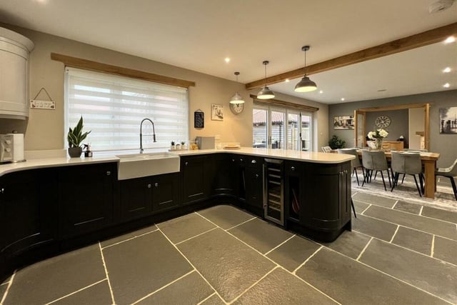 The kitchen, with underfloor heating, has fitted shaker-style units with some integrated appliances, and includes a range cooker.