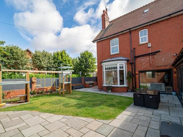 A lawned garden with patio to the rear of the property.