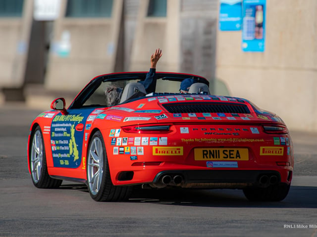 Belinda and James depart in their Porsche 911 'Splash'.