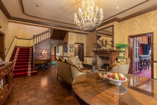 A grand hallway with original oak panelling and parquet flooring leads in to the Manor.