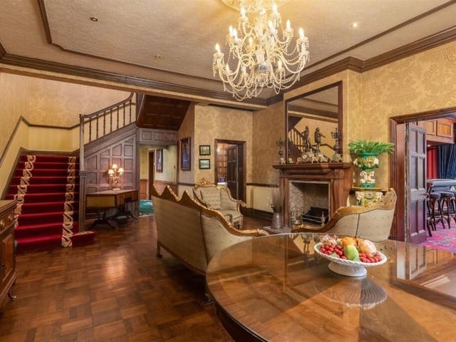 A grand hallway with original oak panelling and parquet flooring leads in to the Manor.