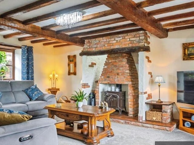 A lounge with a log burner set within the chimney breast.