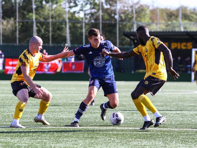 Luca Colville is closed down by two Rushall players.