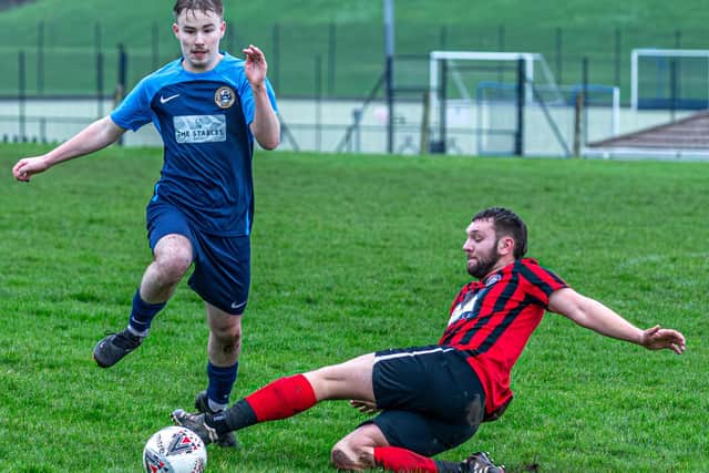 Sinnington look to nick the ball away from Whitby Fishermen’s Society Academy in Beckett League Division 2