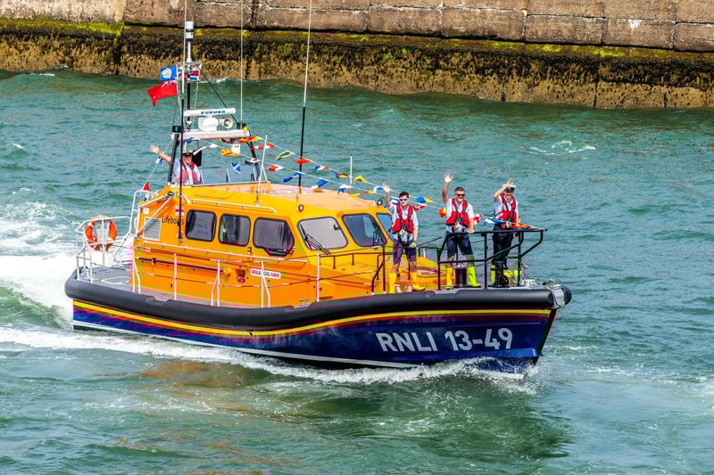 A wave to the crowds from people on board Lois Ivan.
picture: Brian Murfield
