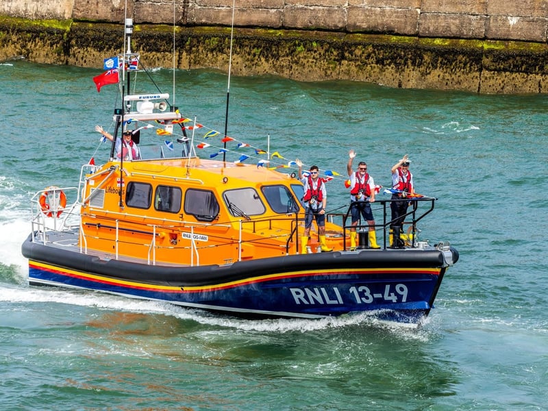 A wave to the crowds from people on board Lois Ivan.
picture: Brian Murfield