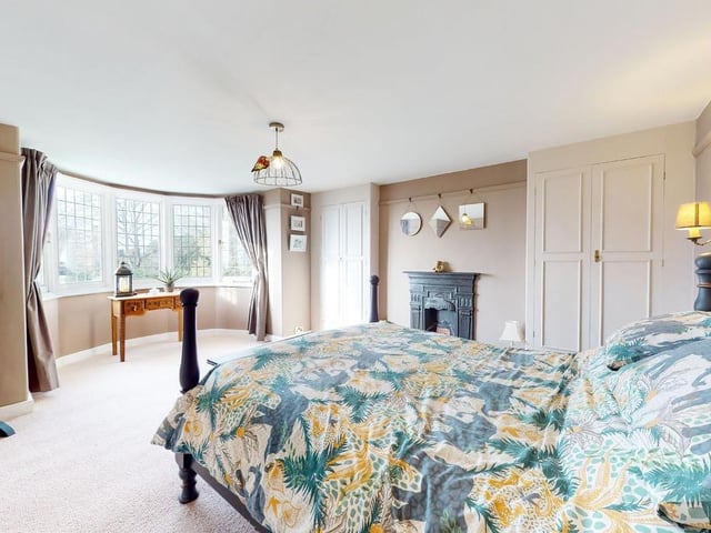 Another stunning bedroom, with bay window and period fireplace.