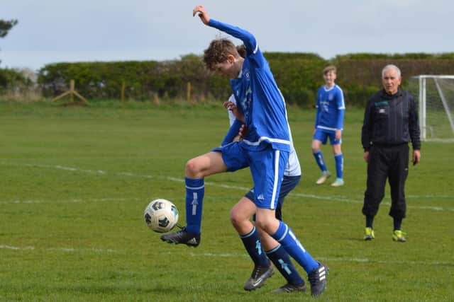 Hosts Heslerton U15s hold off a rival player. PHOTO: CHERIE ALLARDICE