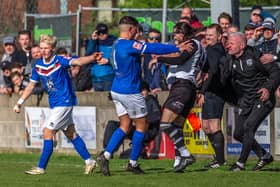 Max Howells with Josef Wheatley pushing Radcliffe's Luca Navarro before the latter's sending-off.