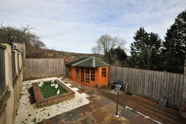 One tier of the garden has a 'sun trap' summerhouse.