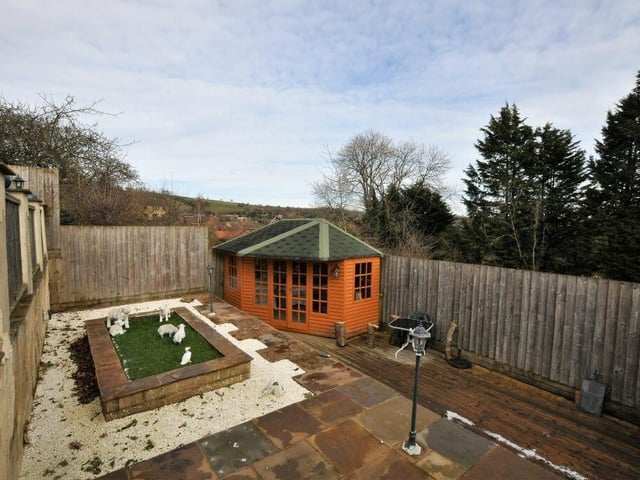 One tier of the garden has a 'sun trap' summerhouse.