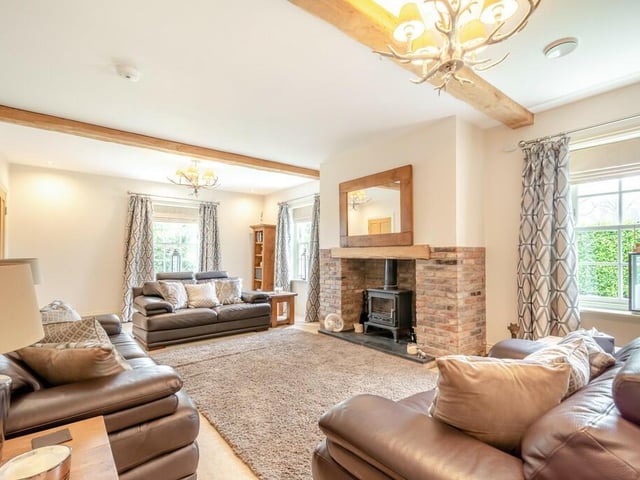 A beamed lounge with feature fireplace.