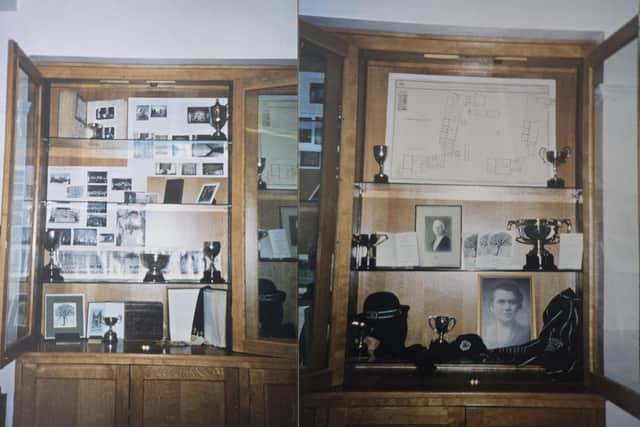 The various objects include trophies and photographs.