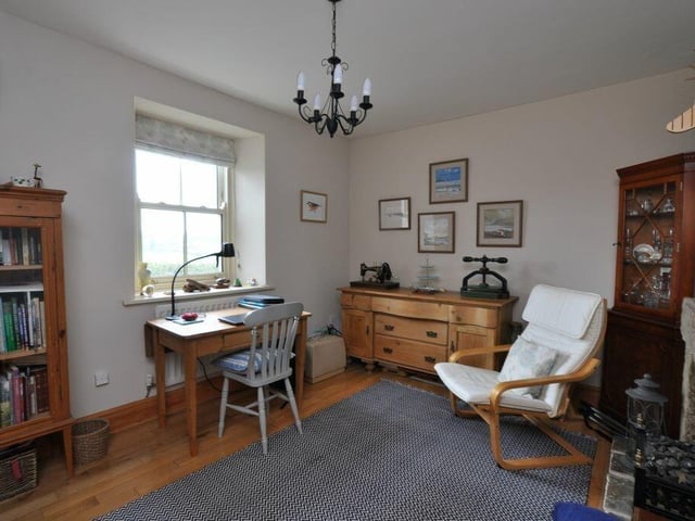 A room of flexible use with a stone fireplace.